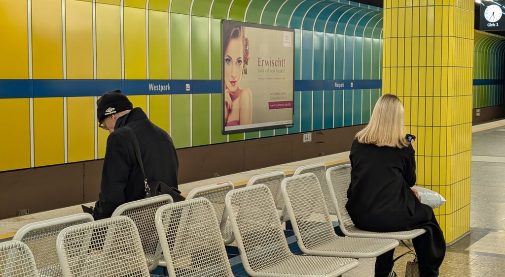 yellow green, blue walls, metro station, white chairs, two passengers, female, blonde hair, man