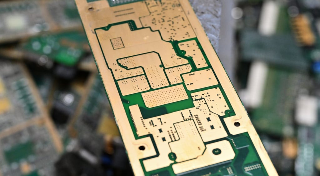 close up of short circuit board, little metal plate of gold and green, silver,