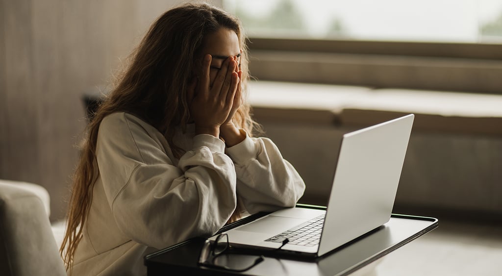 young woman using infected computer
