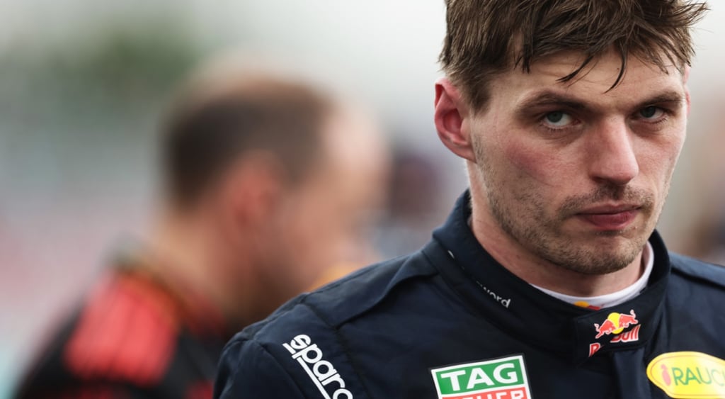 Max Verstappen, white man, dark brown hair, tired eyes, scar on left cheek, tired baggy eyes