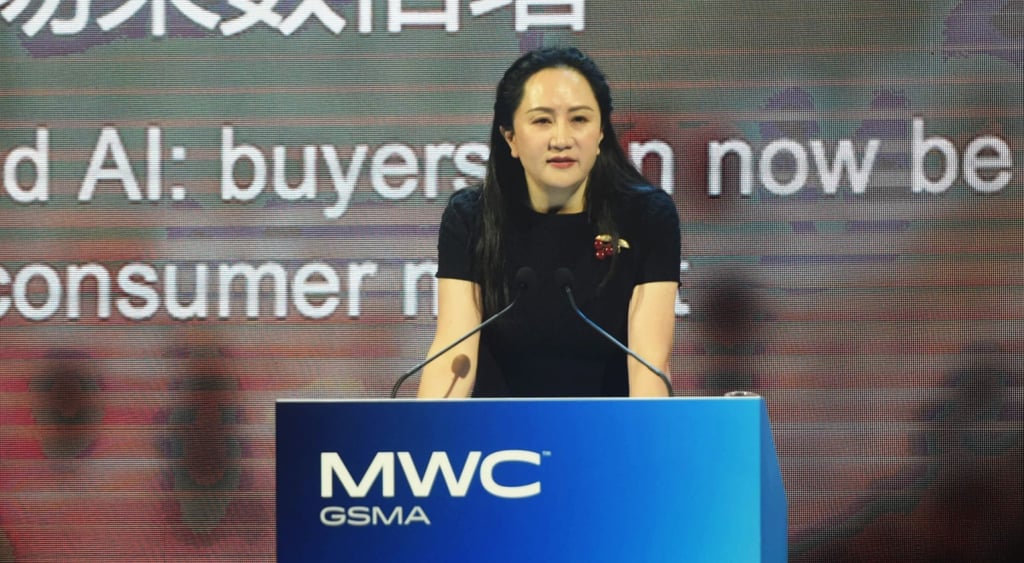 Meng Wanzhou, young asian woman, MWC whitel etters, blue stand, brown photo wall