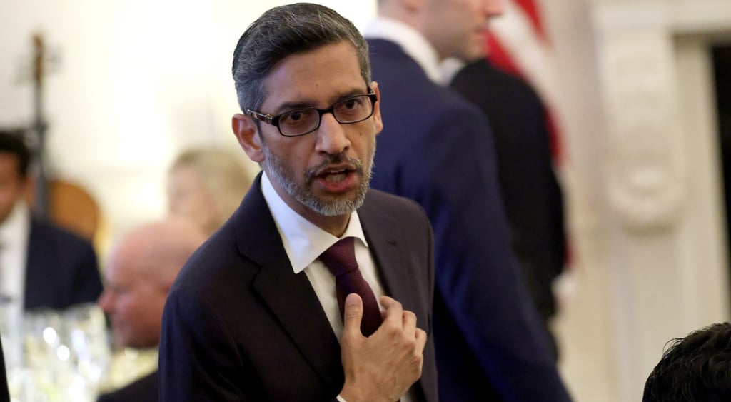 Google CEO Sundar Pichai, black suit ,dark red tie, light brown skin, right hand fixes tie, glasses