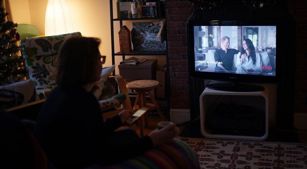 megan parkle, prince harry on tv screen, christmas tree, woman with tv remote controller