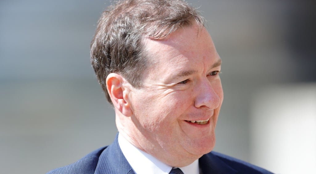 George Osbourne, pale white skin, smiling, dark blue suit, white shirt