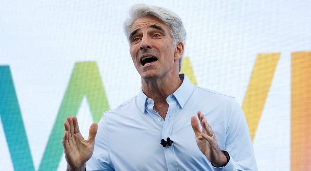 Craig Federighi, light blue collar shirt, no tie, white man, grey hair,