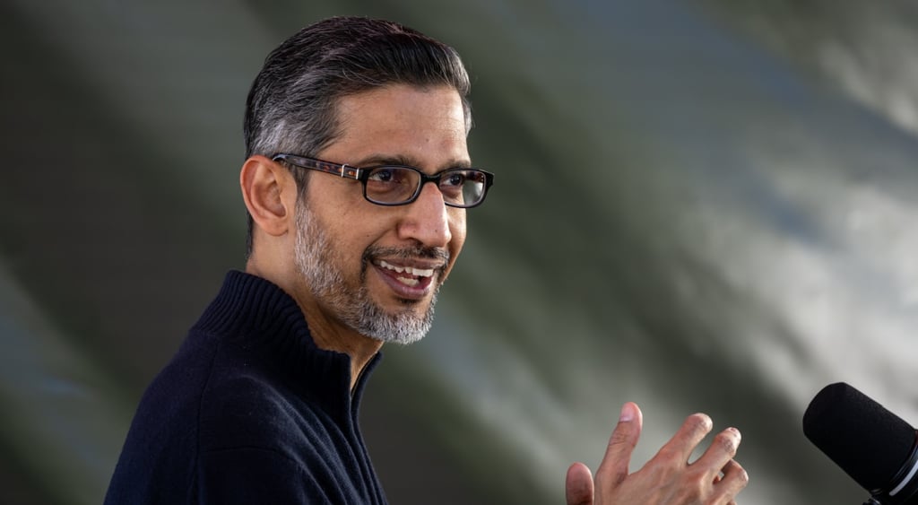 sundar Pichai, black and grey hair, glasses, indian man, grey background, black shirt