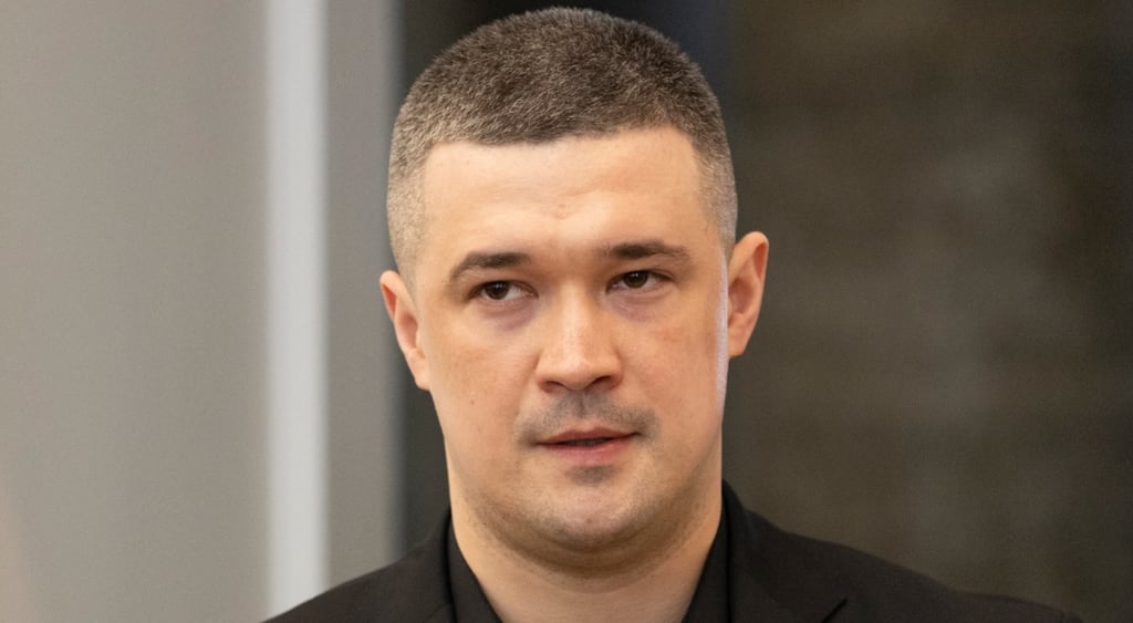 Mykhailo Fedorov, young man in black suit, white skin, very shortly cut dark hair,