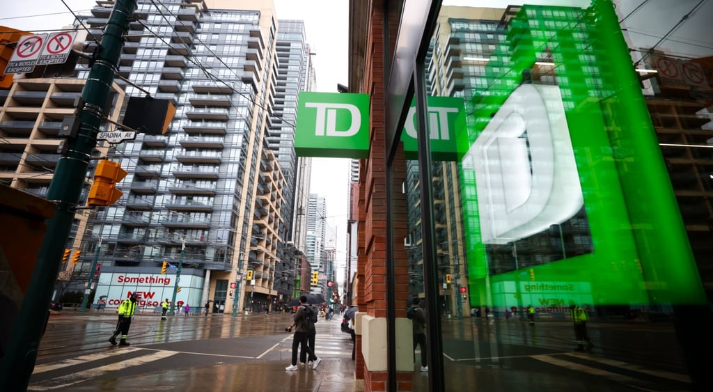 Toronto Dominion Bank logo, green background, white D, tall glass buildings, green reflection