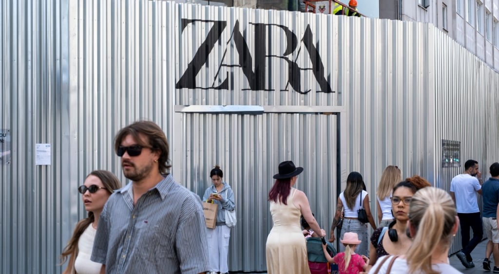 zara logo, metal silver wall, man in black sunglasses, woman white dress, stroller, light blue shirt