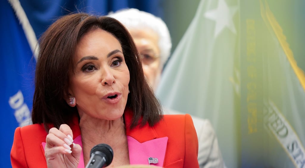 Jeanine Pirro, latin woman, dark brown hair, dark pink jacket, bright pink squirm