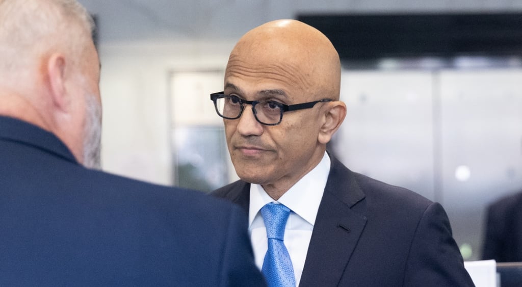 Satya Nadella, middle aged brown skin bold man, baby blue tie, white collar shirt, suit, glasses
