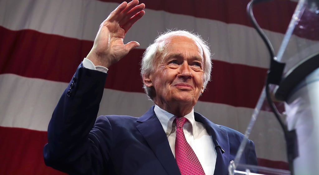 Senator Ed Markey, us flag white and red stripes, wave, white old bald man with white hair, red tie