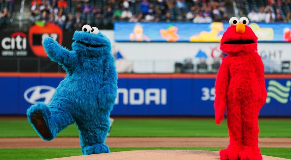 baseball field, blue hairy cookie monster, live size red hairy elmo