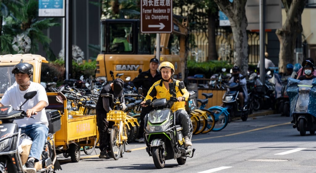 meituan delivery driver, asian male, yellow outfit, yellow helmet, black scooter, grey pavement