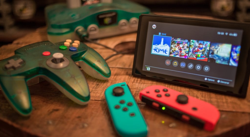 nintendo witch released in 2017, small black screen with video game on, sea blue and orange