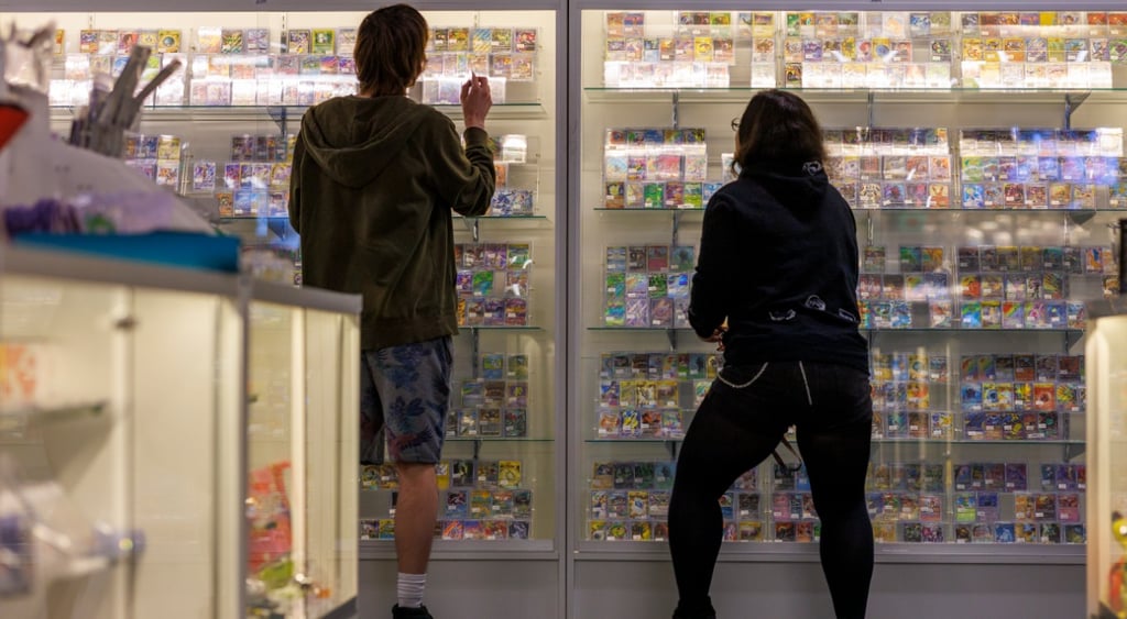 Man and woman looking at Pokemon cards