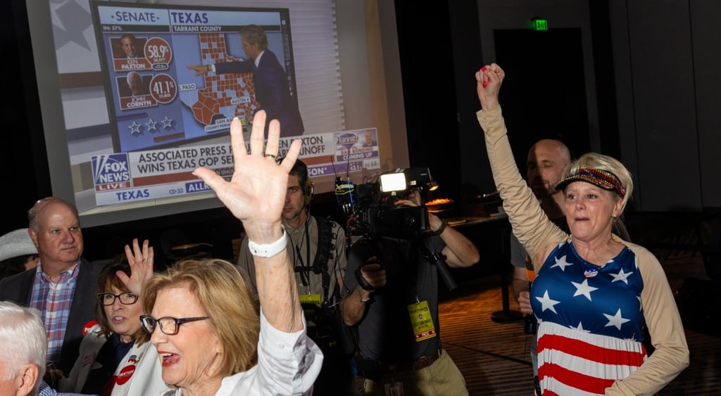 television set, news anchor, white blonde woman wear usa flag outfit, hand up