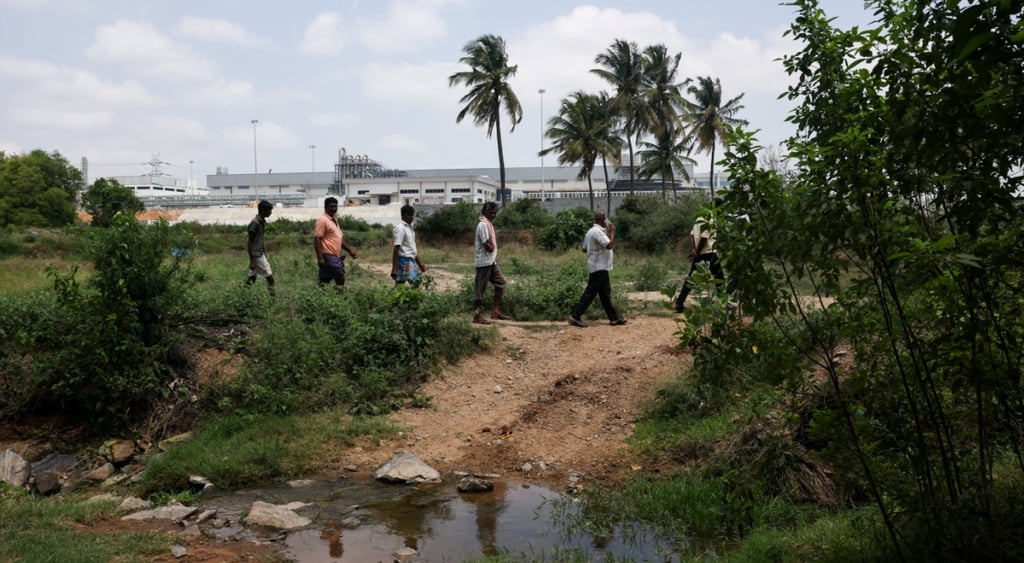 tata iphone white plant in the background, six indian people walk by water and mud, palm trees