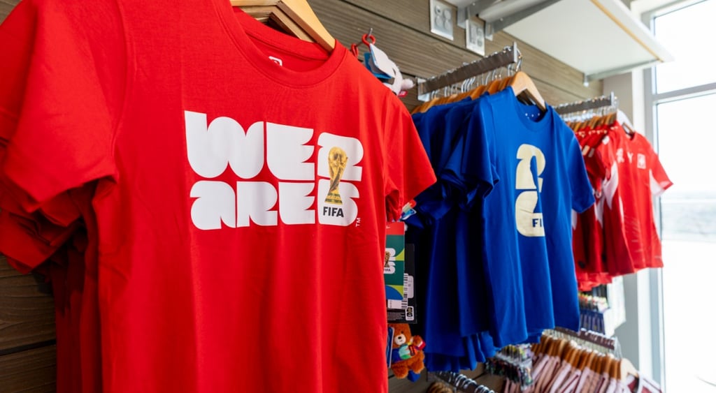 fifa world cup red, blue shirts hangig on wood hangers, we are written in white