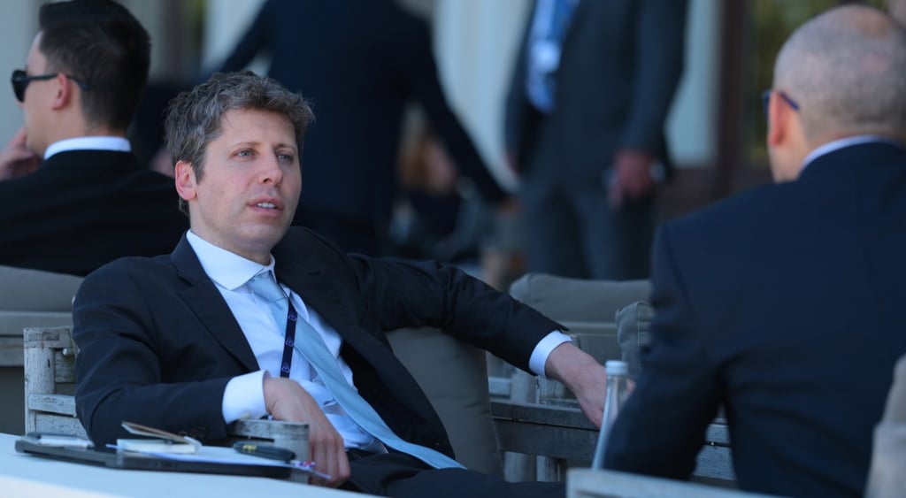 sma altman sits laid back, no tie, white collar shirt, bald man, black suit,