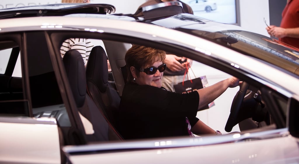 woman in tesla wearing sunglasses