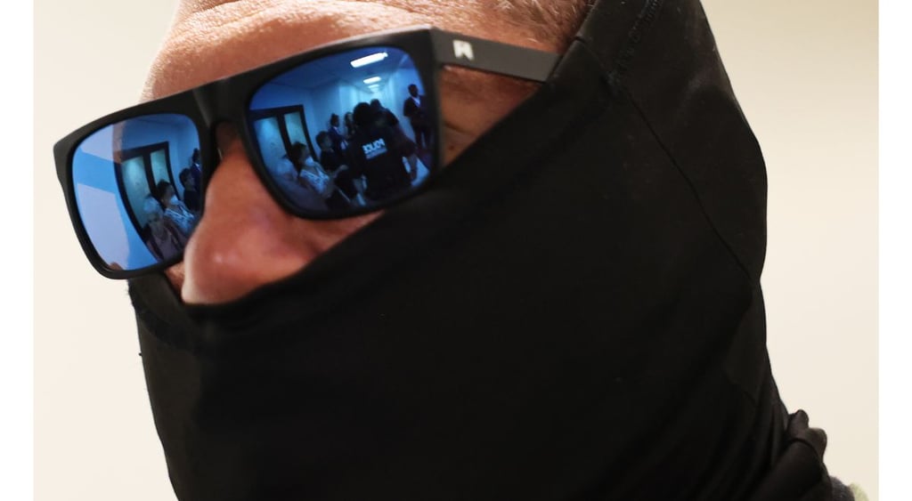ICE agent with glasses closeup