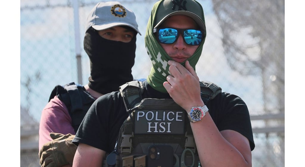 HSI agent with glasses, body cam