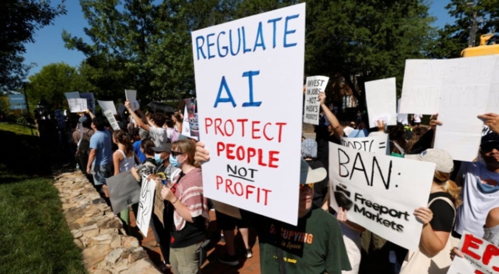 white protest sign, blue letters spell regulate AI, red and black letters, crowd of white people, blue sky