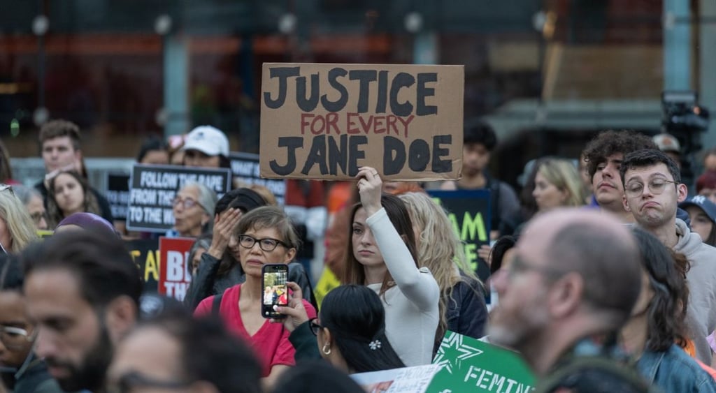 women protest for Jane Doe holding signs demanding justice