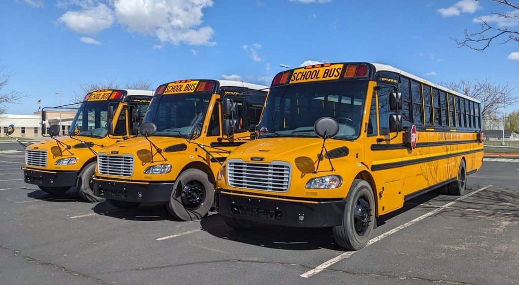 Three Jerome School buses in parking lot