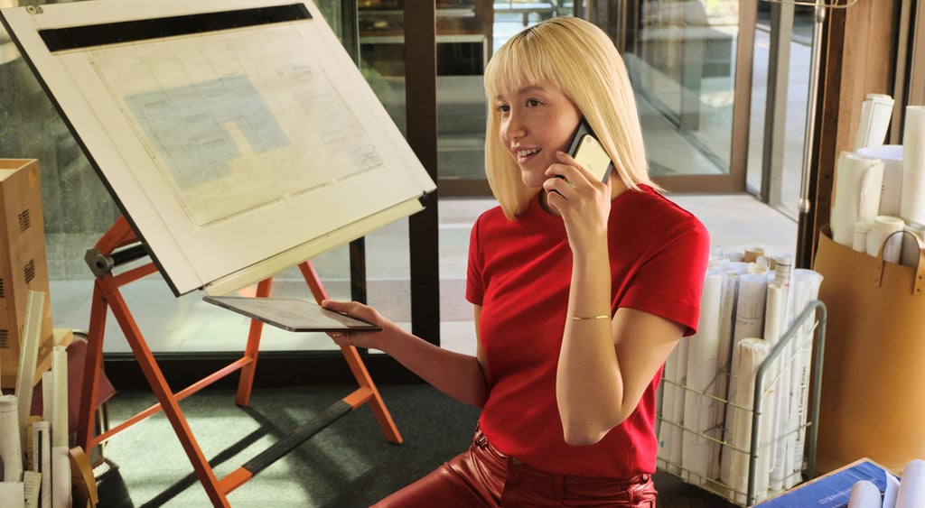 Woman holding a phone with Amazon Bee Eclipse AI assistant