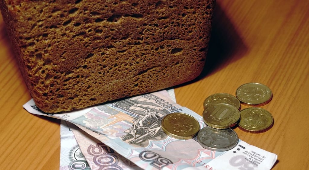 dark loaf of bread with money