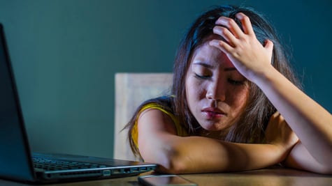 upset teenager by the laptop