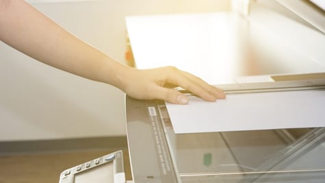 Man copying paper from Photocopier