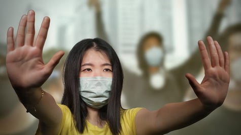 female protesting by holding her hands