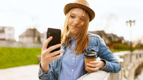 girl taking a photo with smartphone