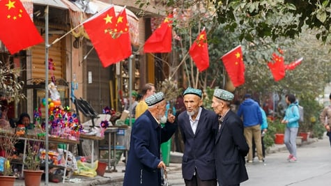 Three men having conversation in Xinhiang