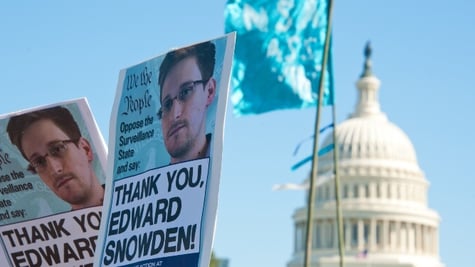 banner with snowden photo in the background of white house