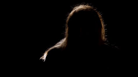 A silhouette of a man in a black background