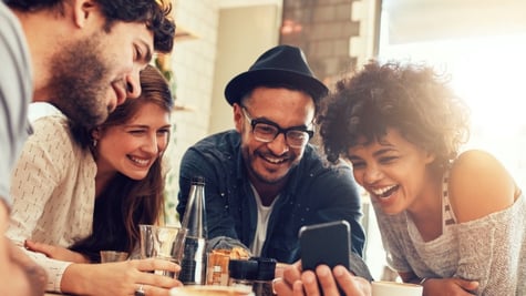 People looking at the phone and laughing