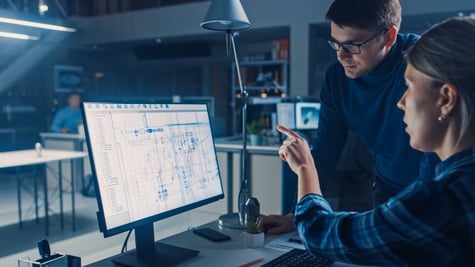 Man and a woman in front of a computer