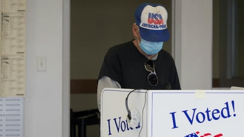 A person casts a ballot for the upcoming presidential election during early voting in Sumter, South 