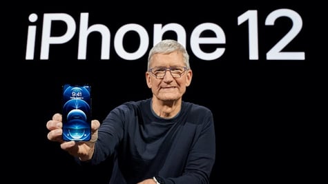 Apple CEO Tim Cook poses with the all-new iPhone 12 Pro at Apple Park in Cupertino, California