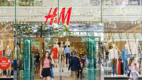 Young woman walking out of H&M store in Brisbane stock photo-3