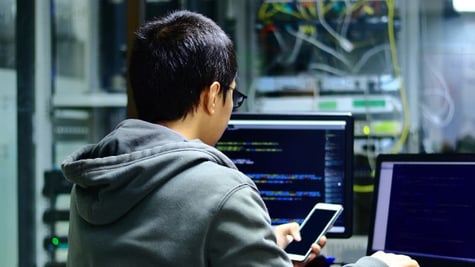 Hacker in front of computers