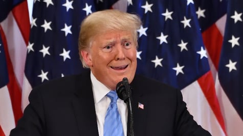 President Donald Trump gestures to emphasize an issue at a press conference