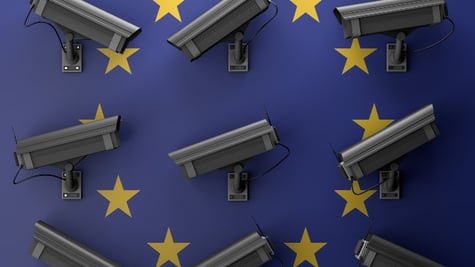 Surveillance cameras hung on wall with EU logo
