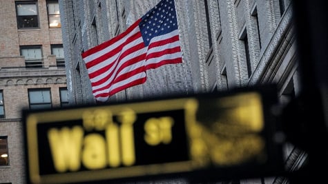 The U.S. flag is seen on a building on Wall St.