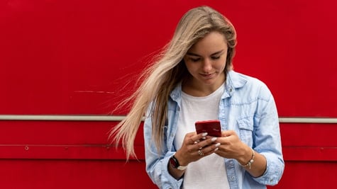 woman blond with a phone smiling