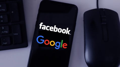 Facebook and Google on mobile screen near mouse